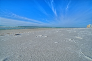 A beach with footprints in the sand and a clear blue sky. - Seachase W 101 2 Bedroom 2 Bath unit. Beach Chair Service for 4 Included (Panama City Beach)