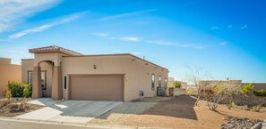 Stunning residential building with a well-manicured front yard and arched entryway.
