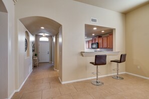 Enjoy cooking in this well-equipped kitchen with a central island and bar stools.