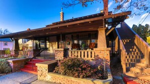 A modern house with a covered porch, brick steps, and a landscaped garden. - Craftsman on Whitman · Updated Craftsman on Whitman, Close to Everything! (Walla Walla)