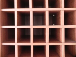 A wooden structure with multiple compartments, likely a storage or display unit. - Planeta Hotel (Colinas do Sul)