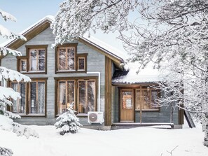 A two-story wooden house with large windows and a snow-covered landscape. - Rome 10 by Interhome (Pudasjärvi)