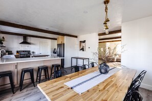 Enjoy cooking in this well-lit kitchen with a central island, oven, and stainless steel refrigerator.