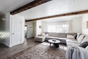 Relax in this inviting living space with a large L-shaped sofa and a cozy coffee table.