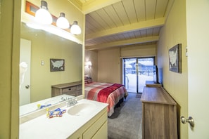 Enjoy a clean and functional space with a large mirror, dresser, and comfortable bed.