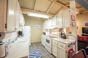Functional kitchen with appliances, cabinetry, and a sink.