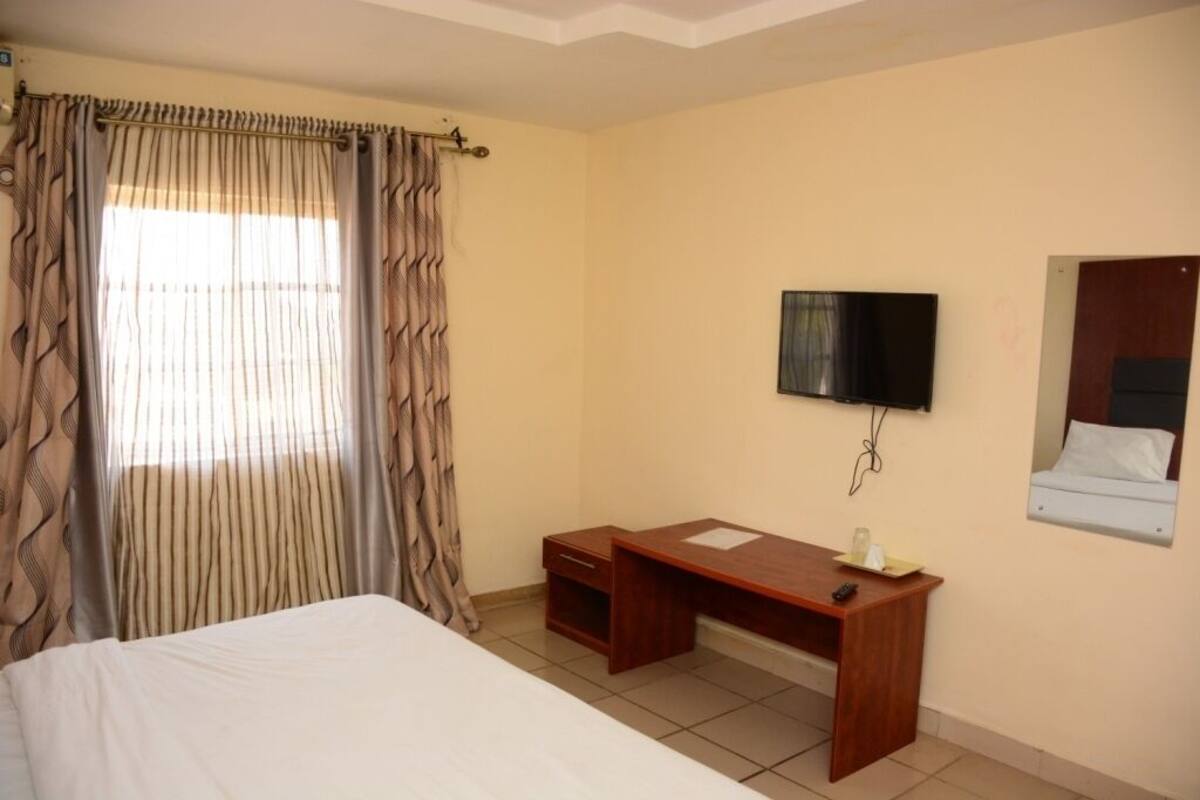 Desk, blackout curtains, bed sheets