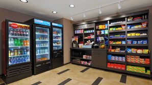 A self-service kiosk with beverage dispensers and snack shelves. - Candlewood Suites Louisville - NE Downtown Area by IHG (Louisville)