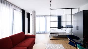 Deluxe Studio Suite | Living area | 46-inch LED TV with satellite channels, TV