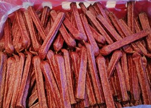 A pile of dried sausages in a plastic bag.
