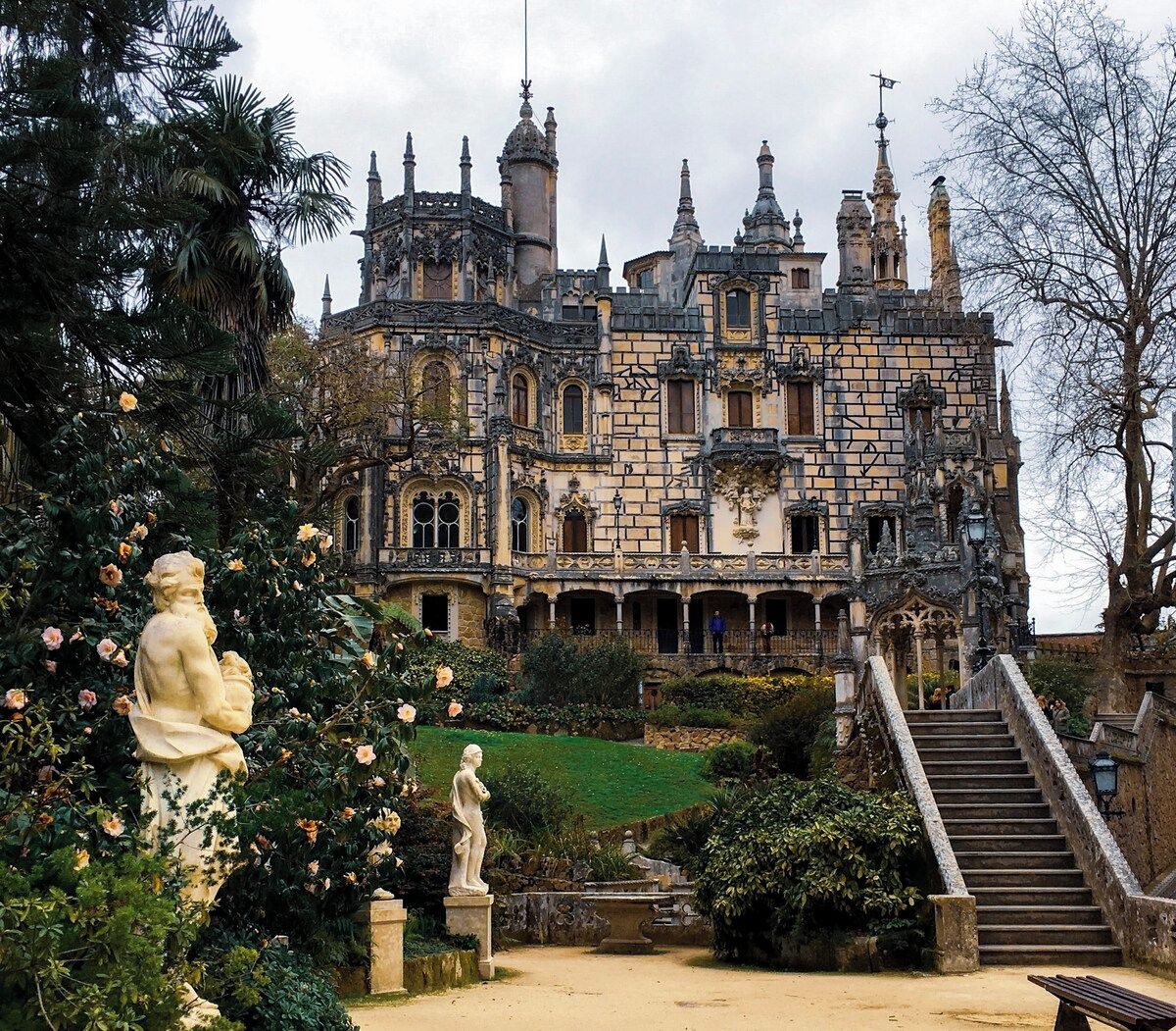 A historic building with ornate architecture, a central courtyard, and a staircase leading to the entrance.