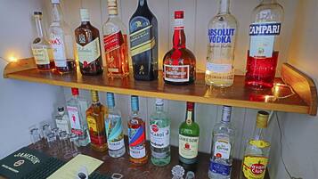 A variety of liquor bottles on shelves, including brands like Jameson, Bacardi, and Absolut Vodka.
