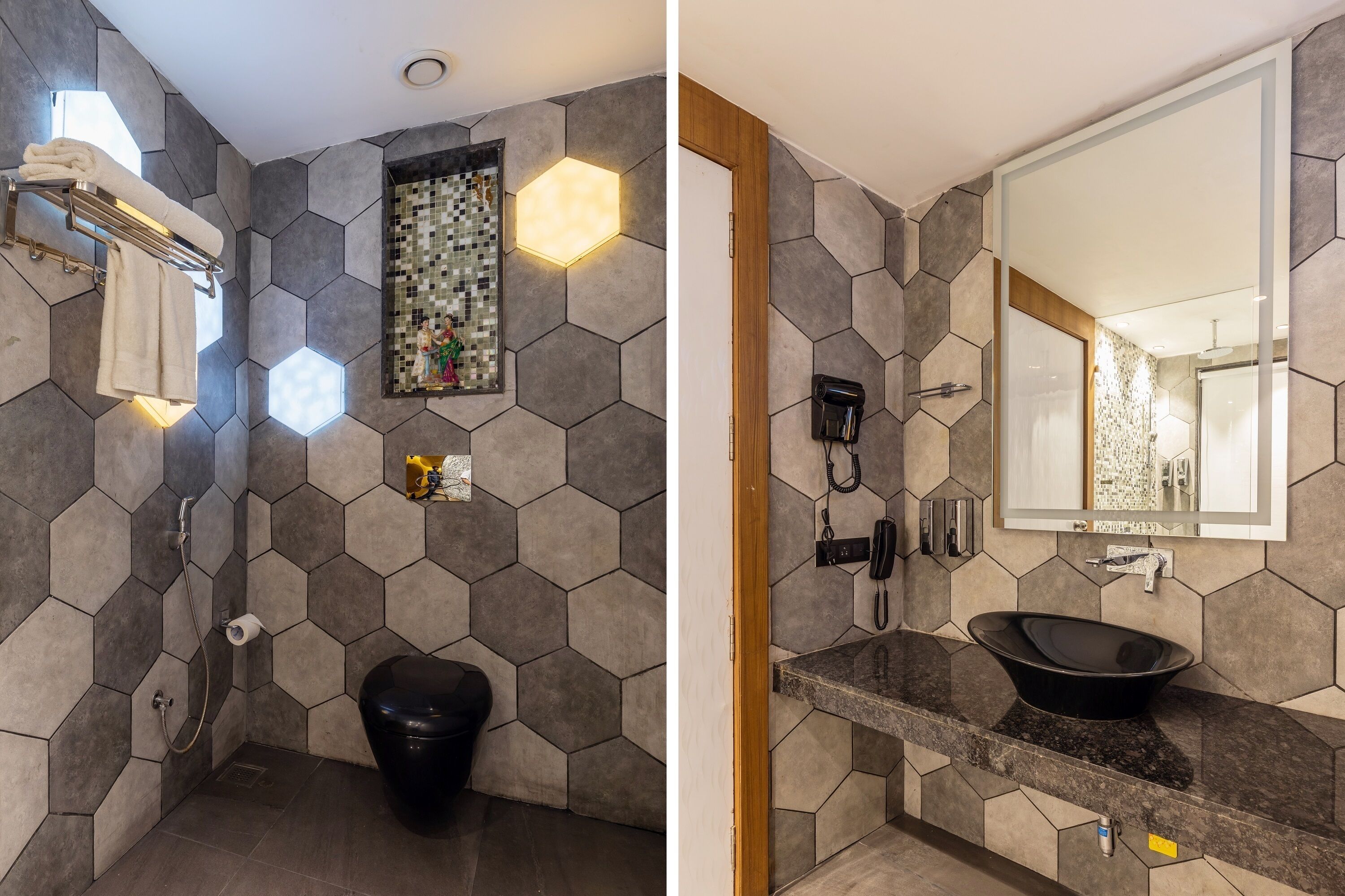Une salle de bain avec des murs recouverts de carreaux hexagonaux, des toilettes noires, un porte-serviettes, une douche et un lavabo avec un receveur noir.