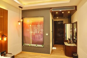A modern hotel room with a large window, a mirror, and a motivational quote on the wall. - Skyline Resort & Convention Centre (Indore)