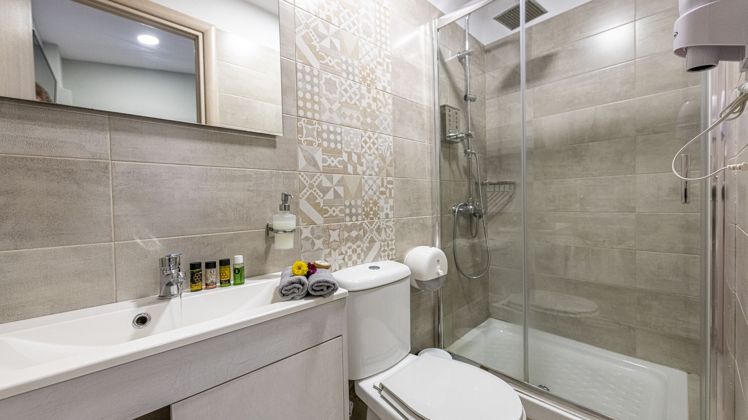 deluxe quadruple room | bathroom | shower, hydromassage showerhead, hair dryer, slippers