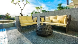 An outdoor seating area with two wicker sofas and a round coffee table. - Milk Homestay (Wujie)