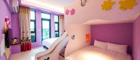 A child-friendly room with a bunk bed, a slide, and a Mickey Mouse figurine.