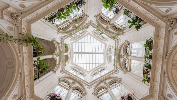 A grand, ornate interior with a central skylight and multiple balconies adorned with plants. - LOFT IN THE CENTER OF BARI NEAR THE CHURCH OF SAINT NICHOLAS  (Bari)