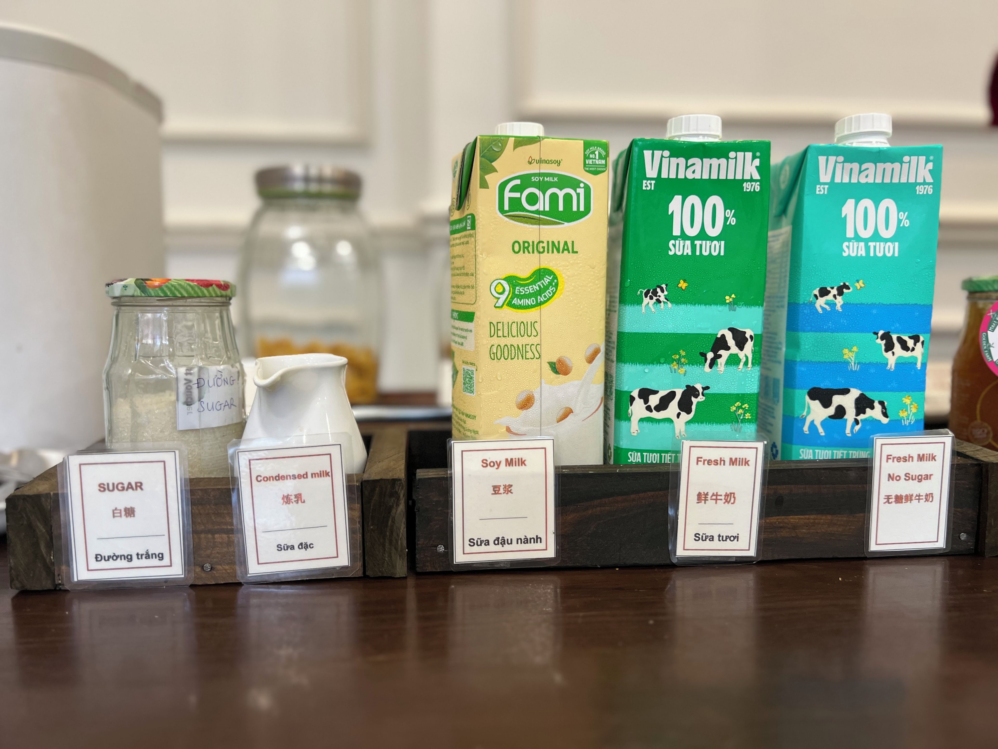 A selection of dairy products including soy milk and fresh milk, with labels in both English and Vietnamese.