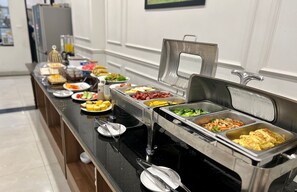 A buffet breakfast setup with various food items and utensils. - Paragon Noi Bai Hotel and Pool (Hanoi)