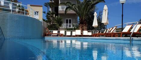 Seasonal outdoor pool, open 9:00 AM to 7:00 PM, sun loungers