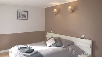 Una camera da letto moderna con un letto, comodini e illuminazione a parete.