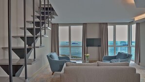 A modern living room with a large window, a staircase, and two sofas. - Best Western Premier Ottoperla Hotel (Istanbul)