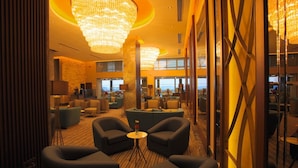 A spacious lobby with modern furnishings, a large chandelier, and a view of the cityscape through large windows. - Best Western Premier Ottoperla Hotel (Istanbul)