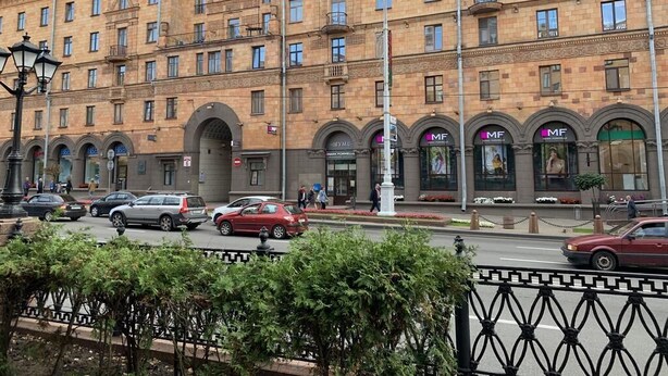 A multi-story building with a classical architectural style, featuring arched windows and balconies.