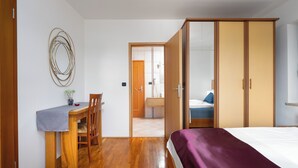 Quarto com cama, escrivaninha e guarda-roupa.