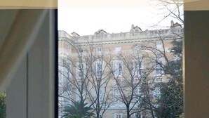 A view of a building with classical architecture, including a prominent balcony and multiple windows. - Royal Gardens B&B Caserta (Caserta)