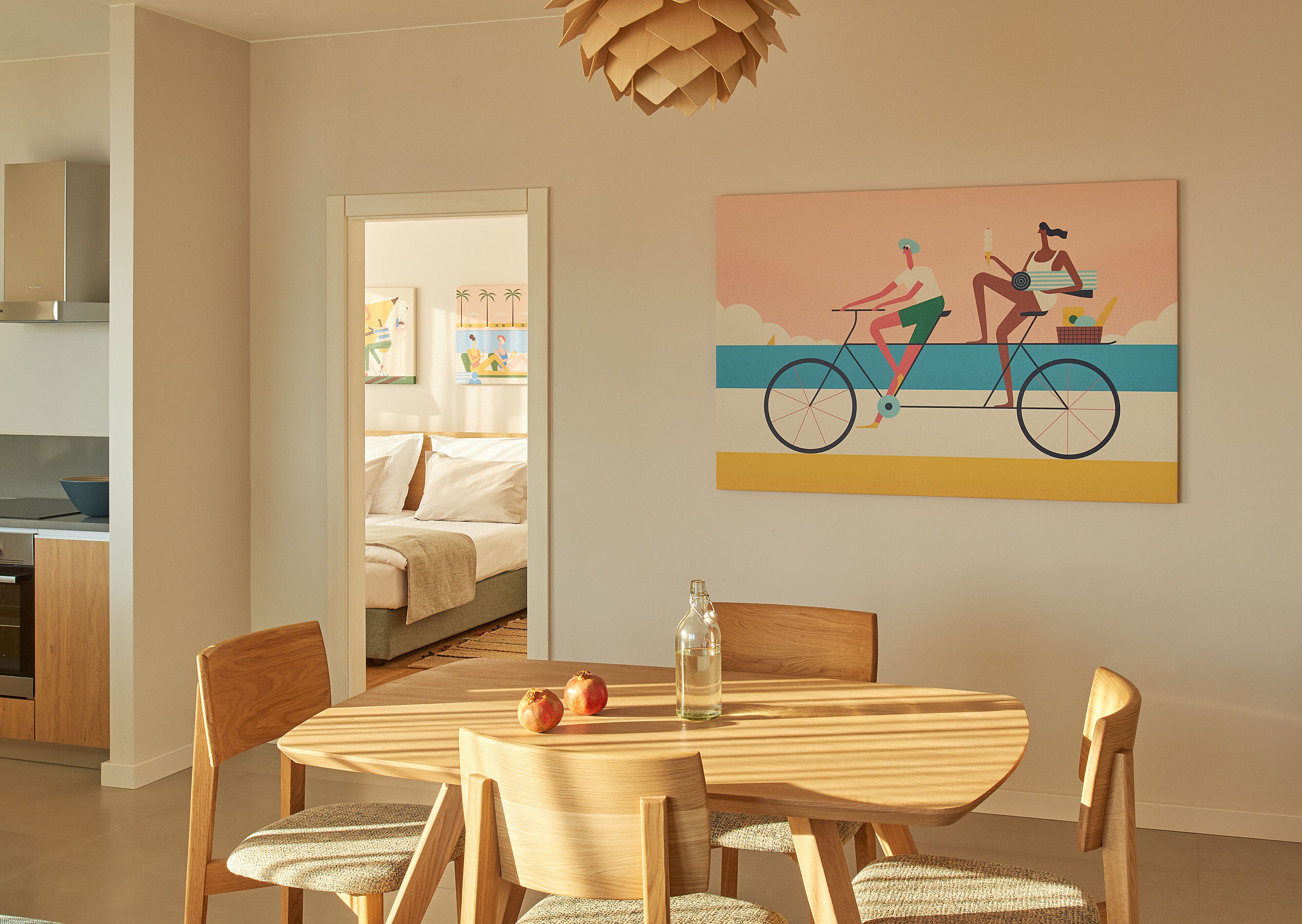 A modern kitchen with wooden cabinets and a dining area with a round wooden table and chairs.