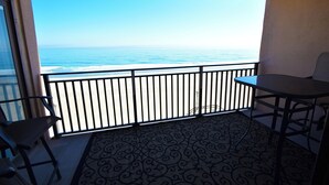 A balcony with a view of the ocean, a patterned floor, and a table and chair. - Ocean Hideaway 404-Oceanfront 18th St, Free WiFi, Elev, W/D, AC (Ocean City)