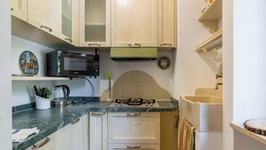 A kitchen with a microwave, stove, and cabinets.