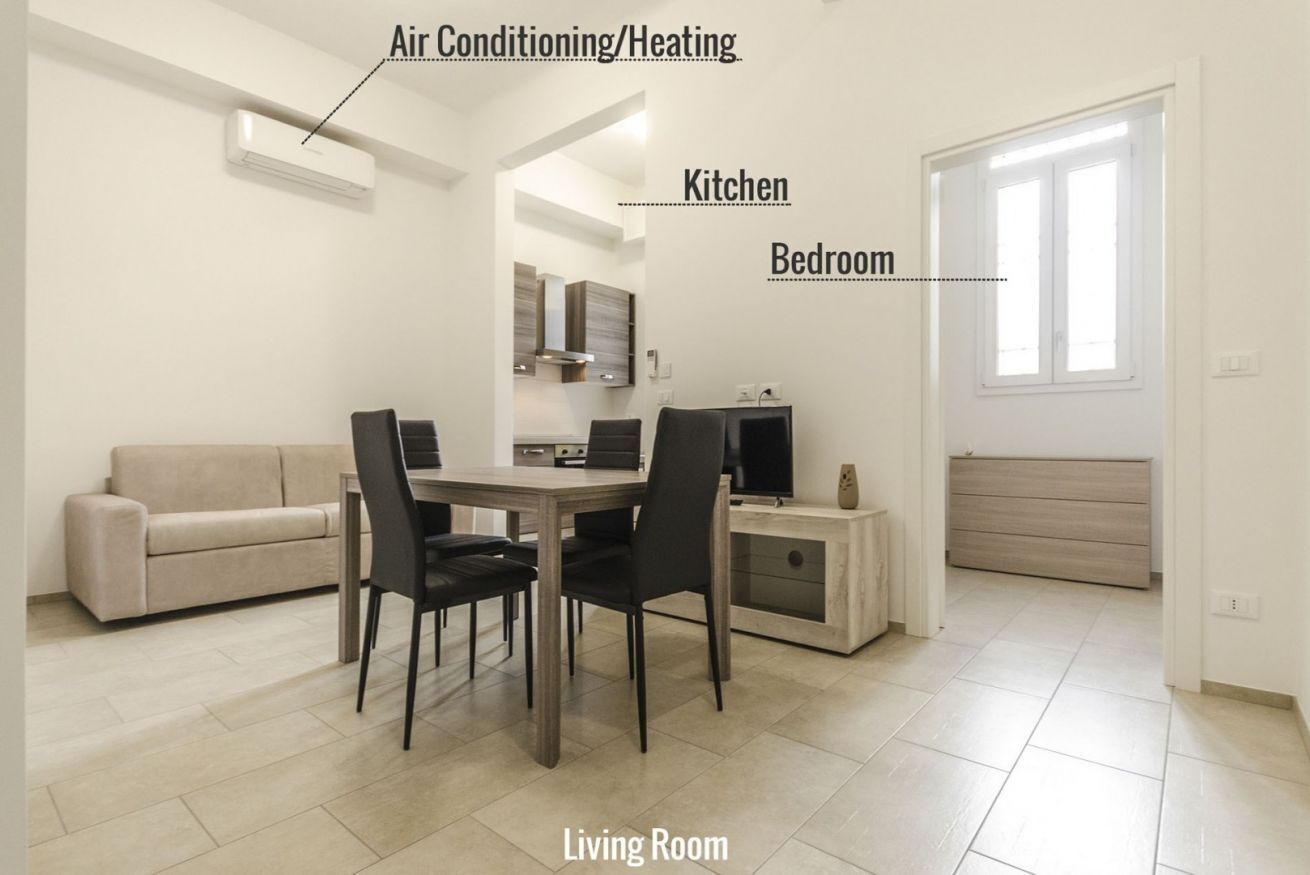 Ein modernes Wohnzimmer mit Essbereich, Küche und Schlafzimmer.