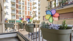 A balcony with potted plants and flower-shaped decorations. - Il Campo Apartments (Bologna)