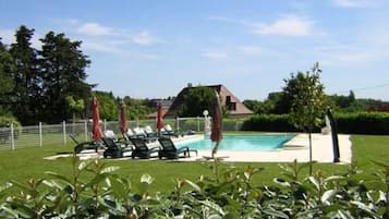 Seasonal outdoor pool, a heated pool, pool umbrellas, pool loungers