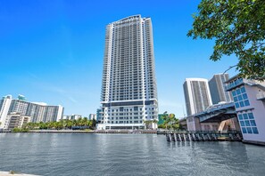 A high-rise hotel with multiple floors, a waterfront view, and a modern architectural design. - Bay views, luxury finishes, and coastal chic in this 1-bedroom heaven (Miami)