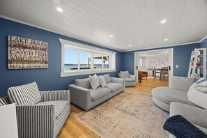 A living room with a grey sofa, striped armchair, and a rug.