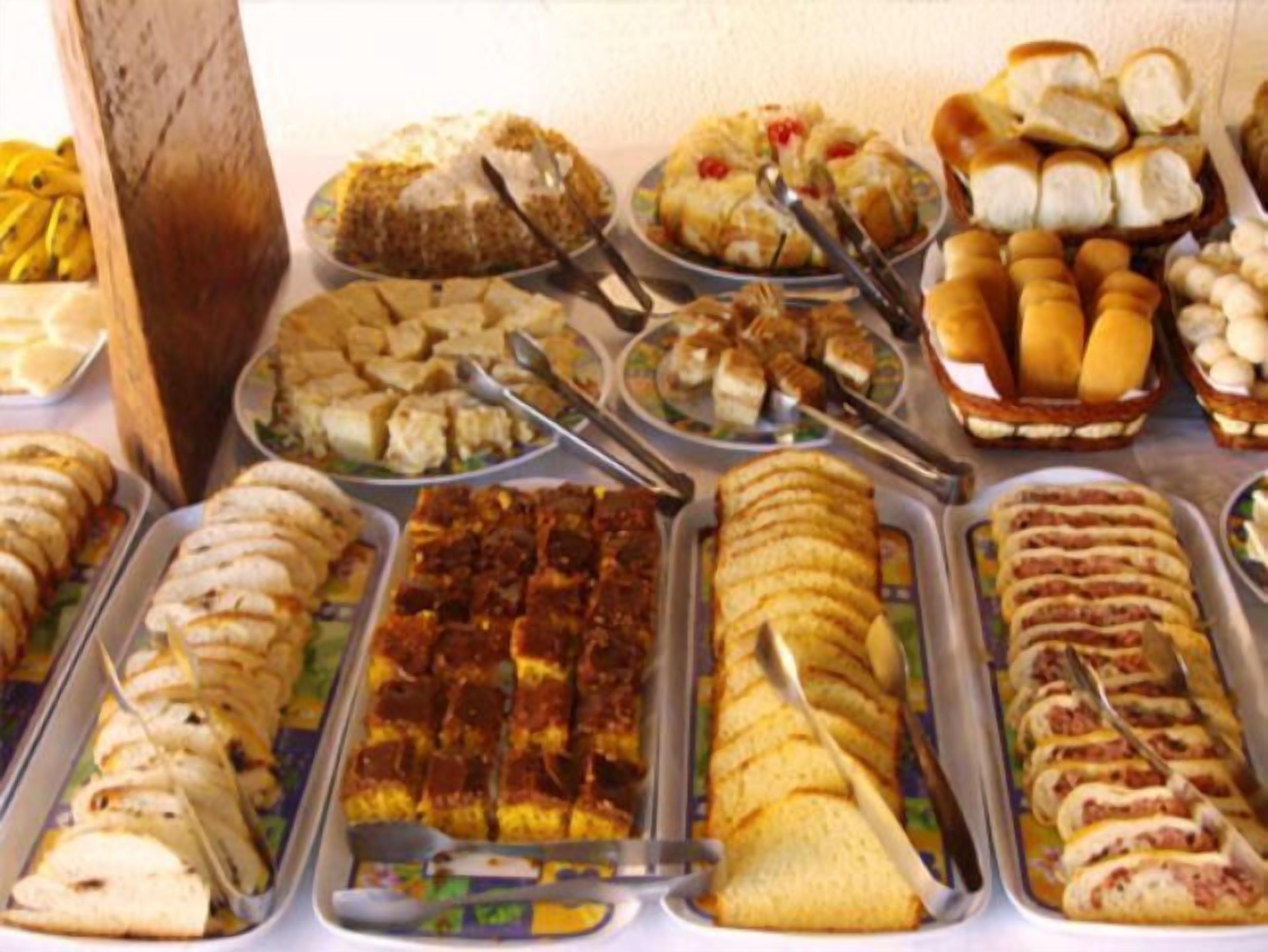 A buffet with various dishes including sandwiches, salads, and desserts.