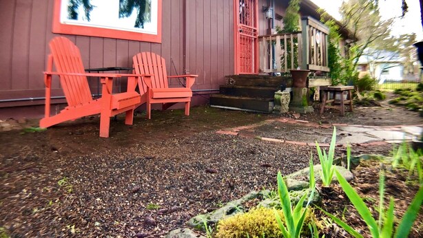 A red house with a porch, two Adirondack chairs, and a small table. - ⭐️Tranquil Hidden Gem in the ❤️ of Woodstock⭐️ (Portland)