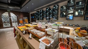 A buffet with various food items and a fire exit sign. - Best Western Kapurthala (Kapurthala)