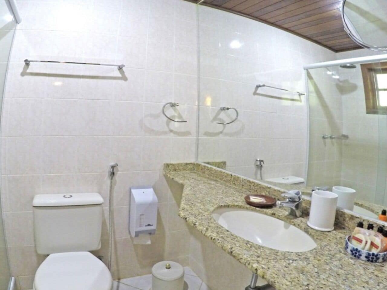 A bathroom with a toilet, sink, and shower.