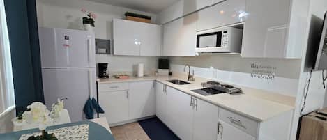 Fridge, microwave, stovetop, coffee/tea maker