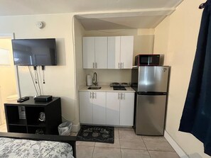 Fridge, microwave, cookware/dishes/utensils, dining tables