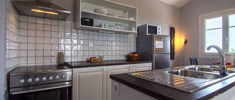 Superior Apartment, Sea View | Private kitchen | Full-sized fridge, microwave, oven, stovetop