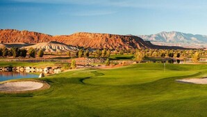 A golf course with a pond, trees, and mountains in the background. - Spacious backyard & 2 pools/spas, fishing pond (Washington)