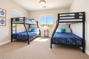A room with two bunk beds, a small table, and a window with a view. - Spacious backyard & 2 pools/spas, fishing pond (Washington)