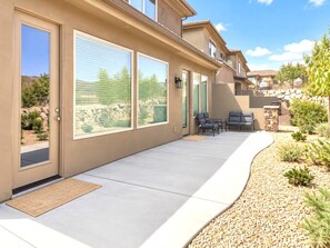 A modern house with a covered patio, large windows, and outdoor seating. - Spacious backyard & 2 pools/spas, fishing pond (Washington)