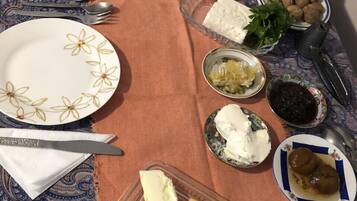 A table set with various food items including cheese, olives, and nuts.
